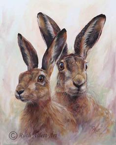 two brown rabbits sitting next to each other