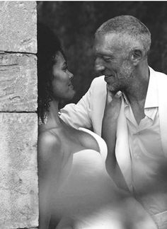 black and white photograph of man and woman looking into each other's eyes, smiling