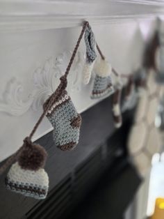 there are knitted stockings hanging on the mantle