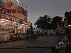 people are standing in front of a food truck