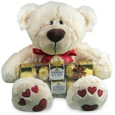 a white teddy bear with chocolates in it's paws and hearts on its chest