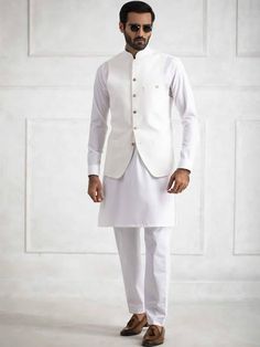 <p><strong>Waistcoat:<br /></strong>Color: White<br />Waistcoat Fabric: PC Suiting Fabric<br />High quality designer waistcoat crafted in pc suiting fabric<br />Fancy button closure</p> <p><strong>Inner:</strong><br />Complement with matching kurta and pajama</p> <p dir="ltr"><br /><strong>Additional Accessories:</strong><br />Peshawari Sandal / Khussa: <strong>US$50</strong><strong><br /></strong></p> Elegant Cotton Nehru Jacket For Festive Occasions, White Sleeveless Cotton Nehru Jacket, Traditional Festive Nehru Jacket For Workwear, Fitted Dabka Kurta For Workwear, Fitted Kurta For Festive Workwear, Festive Fitted Kurta For Workwear, Elegant Cotton Nehru Jacket For Eid, Traditional Bandhgala With Buttons For Workwear, Elegant Fitted Cotton Bandhgala