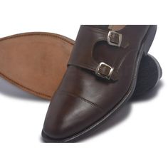 Brown Genuine Leather Monkstrap Formal Shoes Classy and rich dark brown genuine leather shoes The monkstrap closure design ups the style quotient The dual strap are perfect for just the right fitting Belt-buckle strap made of leather adds to the practicality These straps are embellished by silver metallic buckle The undetectable same shade brown stitching is present Natural leather for maximum comfort The elaborate detailing is accented with impeccable surface finish More About Brown Leather Shoes Instantly recognizable clean and smart design with an element of class and trendiness. The interior of a shoe must be padded for utmost comfort and that is the case here as well. Monkstrap shoes are often considered on a casual side due to their chic and stylish design. However, with time they ha Monkstrap Shoes, Shoes Classy, Leather Top Hat, Purple Leather Jacket, Leather Formal Shoes, Oxford Brogues, Closure Design, Brown Oxfords, Bit Loafers