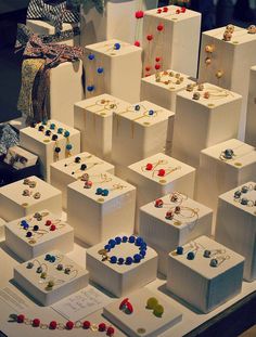 many white boxes with different colored beads on them