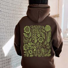 This sage green flower hoodie is the perfect way to add some color and style to your wardrobe. The beautiful floral design stands out against the muted green background, making it a unique and eye-catching piece. Stay warm and fashionable with this cozy and stylish hoodie. ♥ We want you to be happy with your item, and for it to bring you joy! If you have any problems with your order or your item, please contact us prior to leaving a review. We will do what we can to take care of you and ensure t Brown Hoodie Sweatshirt For Spring, Spring Khaki Hoodie Sweatshirt, Green Hoodie For Fall, Green Hooded Hoodie For Spring, Trendy Green Sweatshirt For Spring, Trendy Green Hoodie For Spring, Green Hoodie For Spring, Trendy Green Hoodie Sweatshirt, Green Hoodie With Drawstring For Spring