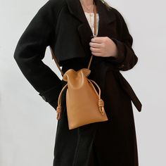 Add a touch of understated elegance to your ensemble with the Amber-Leather Pouch-Bag. This versatile handbag, crafted from high-quality leather, boasts a unique pouch design with knotted details for an effortlessly chic look. The warm amber hue complements any outfit, making it a perfect accessory for both casual and formal occasions. With its adjustable strap, you can carry it as a shoulder bag or crossbody for hands-free convenience. Spacious enough to hold your essentials, this stylish pouch-bag combines functionality with fashion, making it an essential addition to your accessory collection. Leather Suitcase, Luxury Crossbody, Drawstring Bucket Bag, Womens Purses, Leather Pouch, Pouch Bag, Golden Brown, Leather Handbag, Purses And Handbags