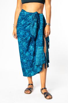 Set your watch to island time and embrace the artistic origins of our tasseled sarong wraps. Dyed with the traditional Indonesian batik method, the colors on this batik sarong are bright and vibrant, and the patterns are uniquely boho chic! From its traditional South Pacific use as a woman's or man's wrap skirt to a hippie skirt, a wall hanging, turban, tablecloth or window dressing, you will never run out of options with a beautiful batik sarong! All Mexicali Blues batik items are handmade in B Traditional Batik Print Sarong For Vacation, Bohemian Batik Print Sarong For Festival, Blue Bohemian Sarong With Traditional Patterns, Bohemian Sarong With Traditional Patterns For Beach, Bohemian Sarong With Traditional Patterns For Festival, Blue Batik Print Sarong For Summer, Summer Blue Batik Print Sarong, Multicolor Traditional Sarong For Beach, Bohemian Batik Print Sarong For Vacation