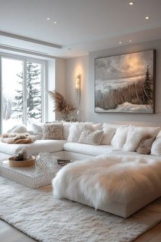 a living room filled with white furniture and large windows