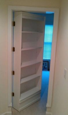 an empty book shelf in the corner of a room