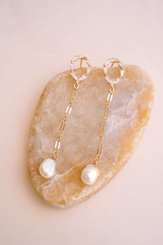 Add a touch of classic, yet glam style with our Gwen Pearl Drop Earrings! These delicate dangle earrings feature an elegant and minimalist design that effortlessly elevates your look! Adorned with freshwater pearls, they're sure to make you stand out. FEATURES Materials: 14K Gold Filled Chain, Pavé Cubic Zirconia, Freshwater Pearls Dimensions: 2.5" drop Glam Style, Glam Fashion, Pearl Drop Earrings, Gold Filled Chain, Pearl Drop, Pearl Jewelry, Freshwater Pearls, Minimalist Design, Gold Filled