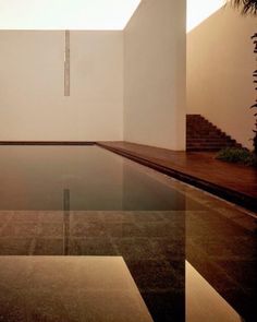 an indoor swimming pool with steps leading up to it