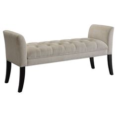 an upholstered bench with black legs