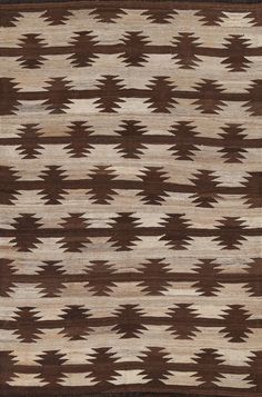 an area rug with brown and white designs