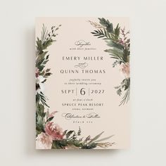 an elegant floral wedding card with greenery and pink flowers on the front is shown