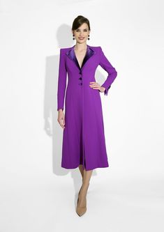 a woman wearing a purple dress and jacket