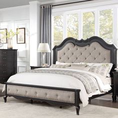 a bedroom with a large bed, dresser and mirror in it's center area