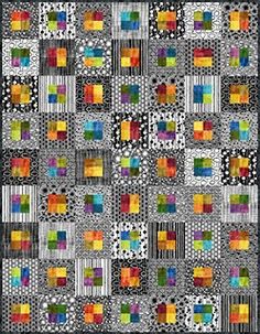 a colorful quilt with squares and dots on the front, as well as a black background