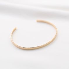 "14K gold cuff bracelet. 14K Gold Minimalist Cuff Bracelet * 14K solid gold. It is about 3mm x 1mm Please select the size of your wrist. If your wrist is 6\", please purchase 6\" bracelet. (If you order a 6\" bracelet, actual cuff length will be 5\" plus 1 inch opening.) Please read our policies before you place your order. https://www.etsy.com/shop/SashJewelry/policy?ref=shopinfo_policies_leftnav To see other Mother daughter necklace set click here: https://www.etsy.com/shop/SashJewelry?section Everyday Gold Hammered Cuff Bracelet, Minimalist Hammered Cuff Bangle Bracelet, Minimalist Hammered Bangle For Everyday, Minimalist Hammered Bracelet Bangle, Minimalist Hammered Bangle Bracelet, Everyday Gold Open Cuff Bracelet, Minimalist Hammered Cuff Bracelet, Hammered Minimalist Bangle, Minimalist Everyday Hammered Bangle