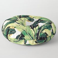 a green and white tropical print round floor pillow