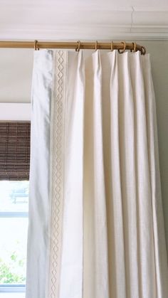 white curtains hanging on a rod in front of a window