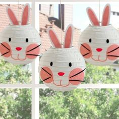 three paper lanterns with bunny ears hanging from the ceiling in front of a windowsill