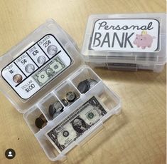 a plastic box filled with money sitting on top of a wooden table next to a small container