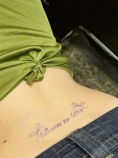 a woman's back with the words born to be written on her lower back