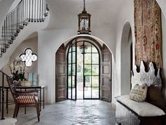 the entryway is decorated in white and features an arched doorway