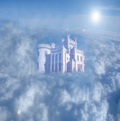 an aerial view of a castle in the clouds