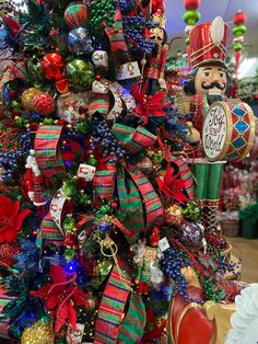 a christmas tree with ornaments and decorations on it in a store ornament shop