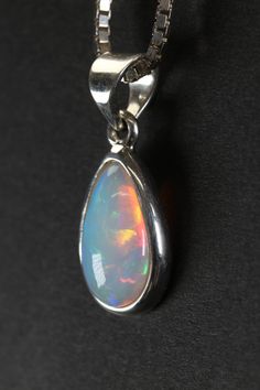 Welo Opal Pendant Approx. Dimensions: 18x10x5 mm This pendant is made with .925 Sterling Silver. Chain is not included. Welo Opal, also known as Ethiopian Opal, is a stunning and highly prized variety of opal that originates from the Wollo Province in Ethiopia. It has gained significant attention in the gemstone world due to its vibrant play-of-color, which rivals that of other well-known opals like Australian Opal.One of the defining characteristics of Welo Opal is its exceptional play-of-color Silver Opal Drop Jewelry, Polished Opal Pendant Jewelry, Fine Jewelry Ethiopian Opal Pendant, Diffraction Of Light, Ethiopian Opal Oval Pendant With Gemstone, Hallmarked Ethiopian Opal Pendant Jewelry, Iridescent Opal Pendant Jewelry, Ethiopian Opal Cabochon Oval Pendant Jewelry, Fiery Red