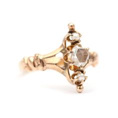 Pretty 15k rose gold Victorian ring featuring a rose cut diamond flanked by two little white seed pearls. Diamond is 5mm in diameter and does have age related wear and inclusions under magnification. Ring size 4.5.Sizing availableLayaway available