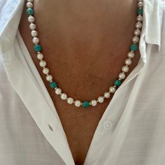 This stunning handmade necklace is a luxurious blend of elegance and natural beauty, featuring 8mm AAA grade natural white round freshwater pearls paired with 8mm round Kingman turquoise beads, sourced from the renowned Kingman Turquoise Mine in Kingman, Arizona, USA. The piece is thoughtfully finished with your choice of gold-filled or sterling silver rondelle spacer beads and a toggle clasp, adding a refined touch to this already exquisite design. The necklace exudes a rich, opulent feel with Elegant Turquoise Necklace With Gemstone Beads, Elegant Turquoise Gemstone Bead Necklace, Elegant Turquoise Necklace With Round Beads, Elegant Turquoise Gemstone Necklace With Round Beads, Elegant Beaded Turquoise Necklace Gift, Elegant Turquoise Gemstone Beaded Necklace, Elegant Handmade Turquoise Necklace With Round Beads, Elegant Turquoise Necklace With Natural Stones, Elegant Turquoise Beaded Necklaces For Weddings