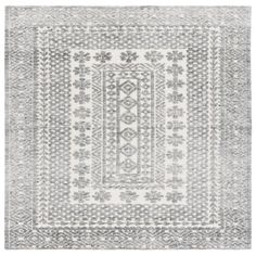 a gray and white rug with an intricate design on the bottom, in front of a white background