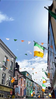 flags flying in the wind on a city street