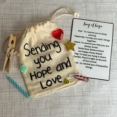 a small bag with some scissors and a note on the side that says sending you hope and love