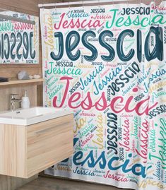 a bathroom with a shower curtain that has the word jesus written in different languages on it