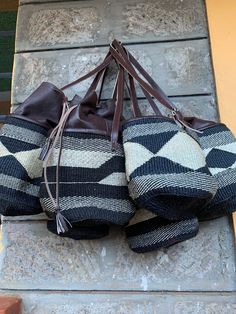 "A beautiful brown and white handbag with leather draw material and handles perfect for all day activities. Dimensions 8\" Kiondo overview A beautiful Multicolored hand bag made of fine weave sisal. It has a zipper and lining. The bag is made of sisal fiber that is hand picked hand prepared into yearn then twisted and weaved. It is finished with natural leather mainly from cow hide. Uses Day out: Its a great bag for use in carrying personal effects such as outdoor mats ,sandals and other picnic Outdoor Mats, Woven Bags, White Handbag, Hobo Bags, Cow Hide, Outdoor Mat, Boho Bag, Woven Bag, Hand Picked