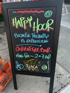 a sign on the sidewalk that says happy hour