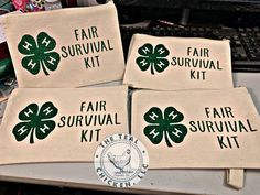 four pieces of cloth with the words fair survival kit written on them in green shamrocks