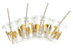 four clear cups with gold giraffes on them