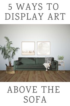 a green couch sitting on top of a wooden floor next to a potted plant