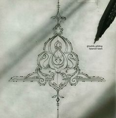 an intricate design is drawn on paper with a pen