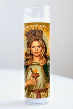 a candle with an image of a woman holding a flower and a crown on it