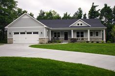 a large house with two garages in the front yard