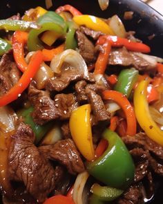 beef and peppers stir fry in a skillet