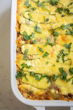 a casserole dish with cheese and herbs