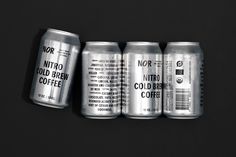 four cans of nutro cold coffee on a black background