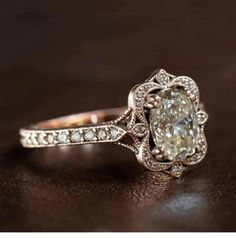 an old - fashioned diamond engagement ring sits on a table