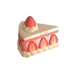 a cake shaped like a strawberry on top of it